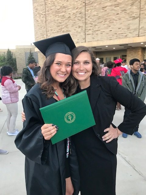 Student and teacher pose at graduation