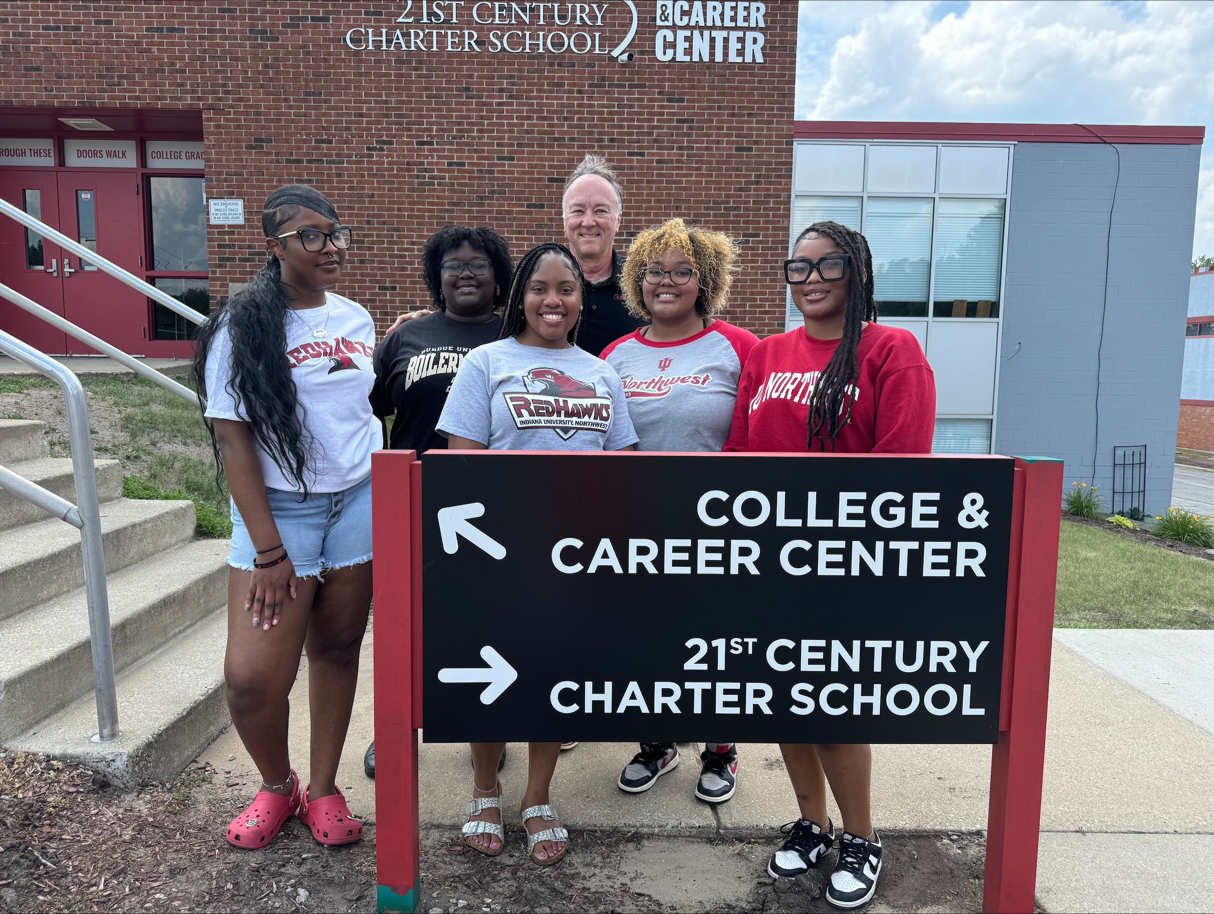 Picture of five students smiling with an administrator