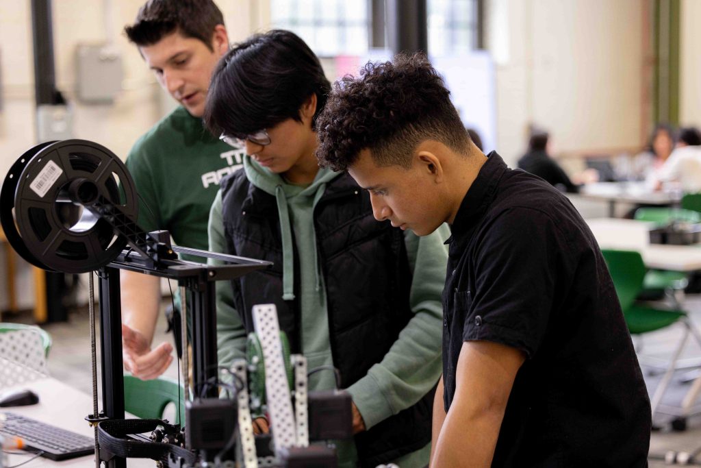 Three students with a microscope